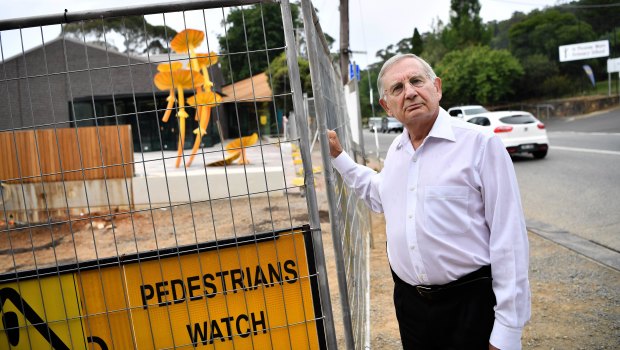Local GP Dennis Gration in front of the unfinished Belgrave community hub. 