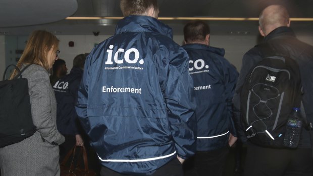 Enforcement officers enter the offices of Cambridge Analytica in central London.