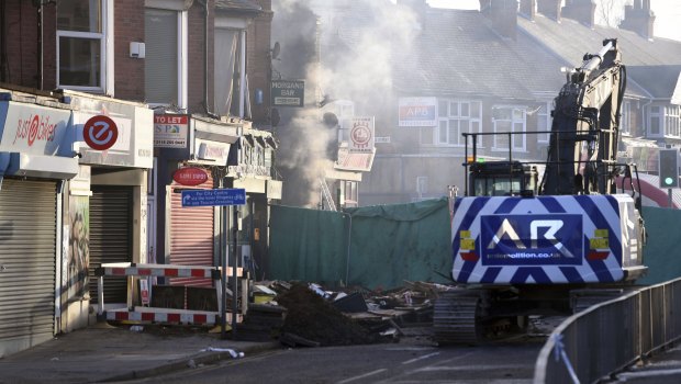 Emergency personnel continue to work at the scene of an explosion and fire Sunday night which destroyed a shop and building above in Leicester, England.