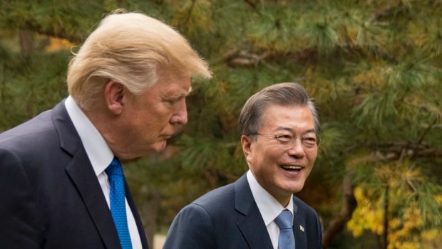 President Donald Trump and South Korean President Moon Jae-in walk through gardens together at the Blue House in Seoul in November.