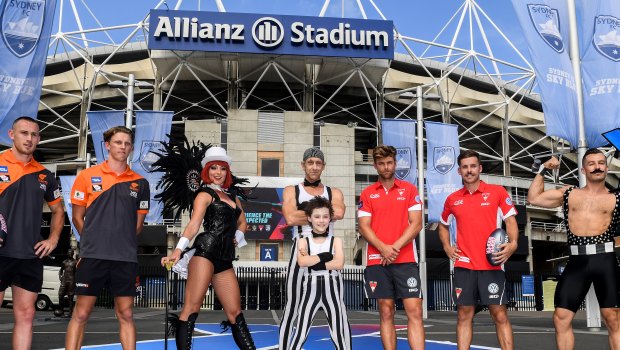 AFL players Tom Scully and Lachie Whitfield (left), of the Greater Western Sydney Giants, with Dane Rampe and Jake Lloyd (right), from the Sydney Swans, stand with circus performers at the announcement of the 2018 AFLX tournament.