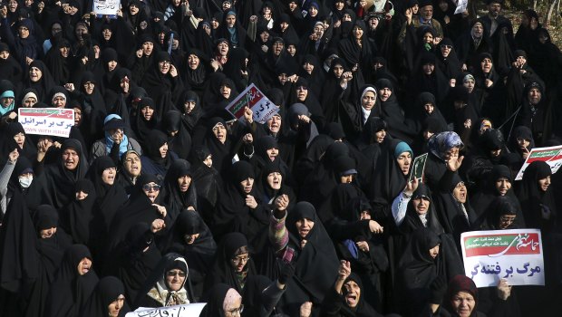 Iranian protesters chant slogans at a rally in Tehran, Iran.