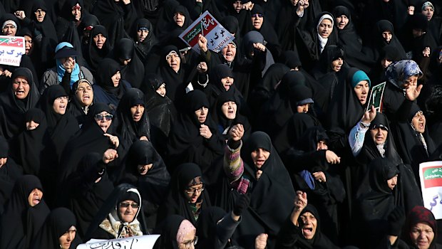 Iranian protesters chant slogans at a rally in Tehran, Iran.