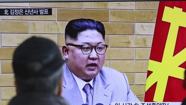 South Koreans watch a TV news program showing North Korean leader Kim Jong-un's New Year's speech.