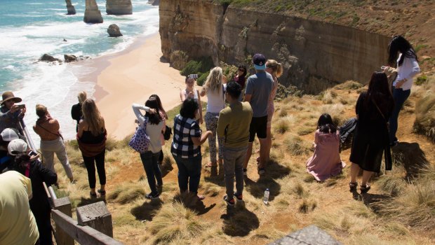 This photo, taken last Thursday, shows tourists who have jumped the barrier to take selfies at the Twelve Apostles.