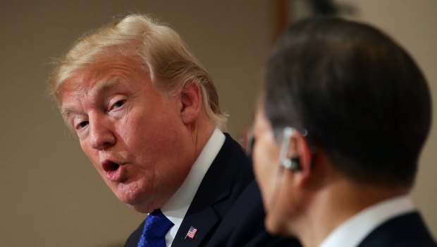 US President Donald Trump, left, looks at Moon Jae-in, South Korea's president in November in the US.