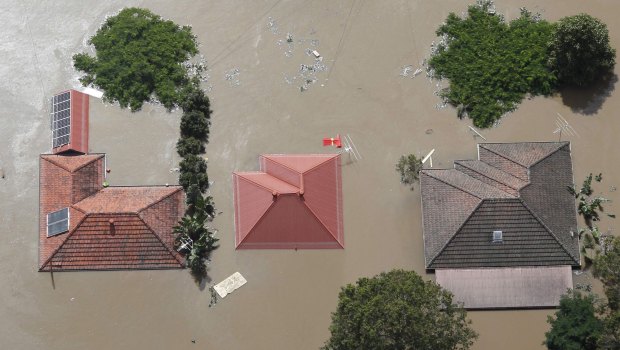 Roofs of houses were visible above flood waters west of Brisbane January 13, 2011. 
