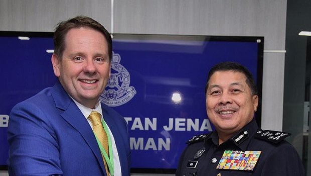 Senior AFP liaison officer Jason Byrnes with Wan Ahmad Najmuddin bin Mohd in 2017. 