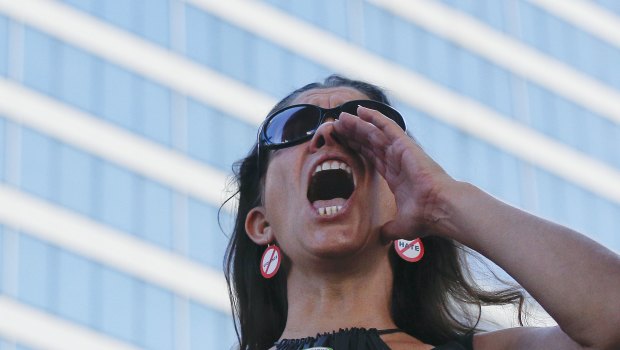 Alessandra Mondolfi holds a sign against AR-15 weapons as she yells, "No More" during a protest against guns on the steps of the Broward County Federal courthouse in Fort Lauderdale, Florida.