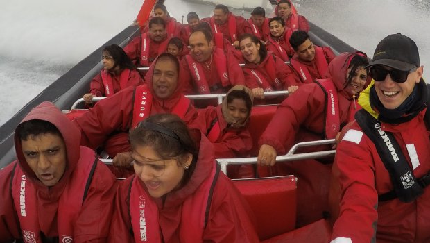 Indian tourists enjoy a jet boat ride on Sydney Harbour