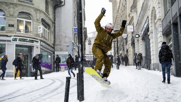 A snowboarder makes the most of it in Lausanne, Switzerland.