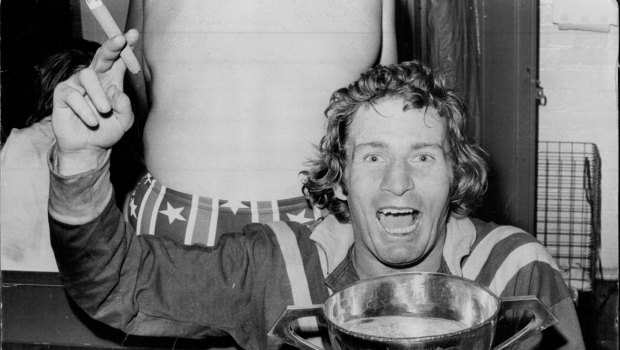 Graeme Langlands, with a cigar in his hand and the Ashes Cup full of champagne in the other, relaxes in the dressing room after leading Australia to their 22-18 win in the third Rugby League Test at the SCG.