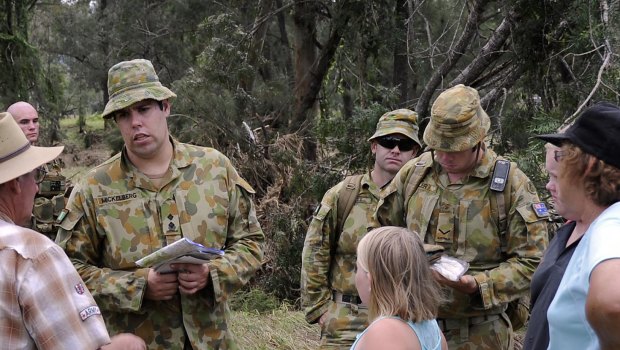 Captain Brent Mickelberg, Platoon Commander, talks to locals during an army operation outside Toowoomba.