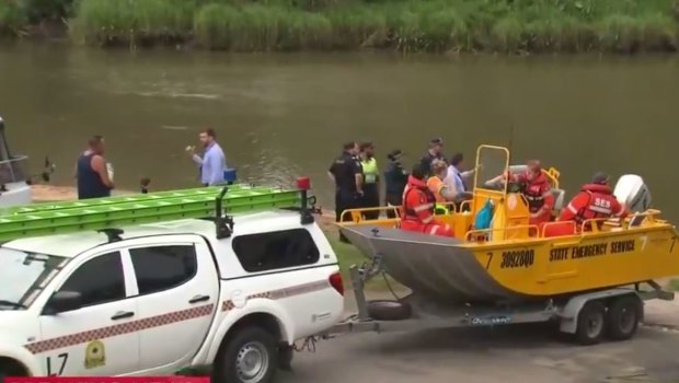 Emergency crews search the Logan River for a woman missing at Waterford West.