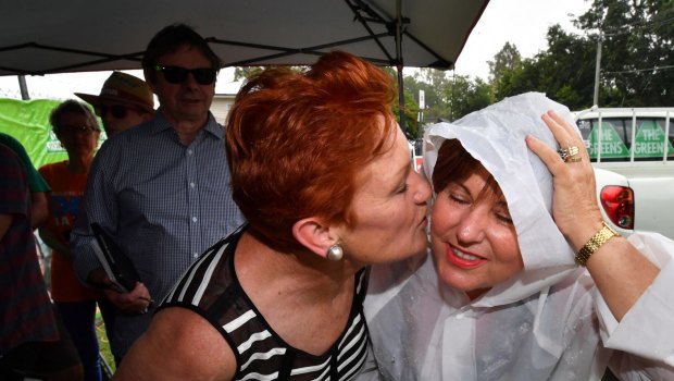 Labor MP Jo-Ann Miller greeted One Nation leader Pauline Hanson with a hug and some booties for her new grandson, despite Labor's attempts to link the resurgent party with the LNP.