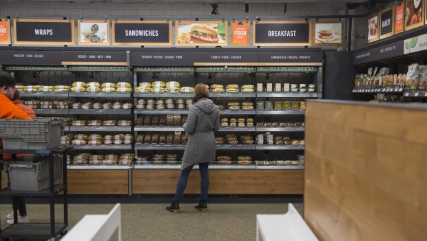 An Amazon.com Inc. employee shops for prepared food at the Amazon Go store in Seattle.