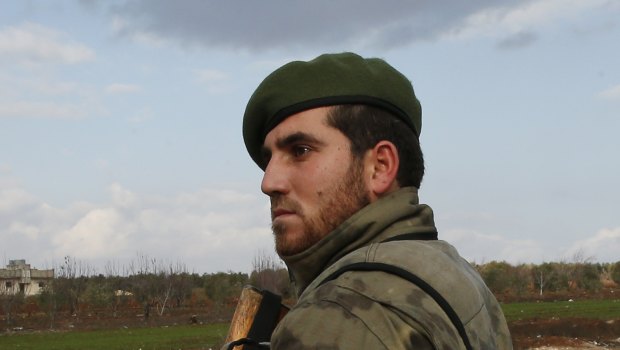 A Turkey-backed opposition fighter of the Free Syrian Army secures a checkpoint at the village of Maarin, in the outskirts of Azaz, Syria.