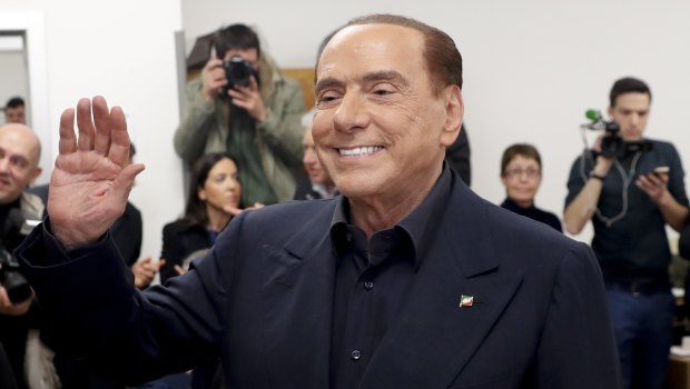 Italian former premier and leader of Forza Italia party Silvio Berlusconi waves at a polling station in Milan, Italy.