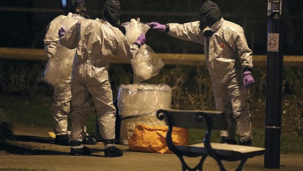 Investigators in protective suits work in Salisbury, England, on Tuesday.