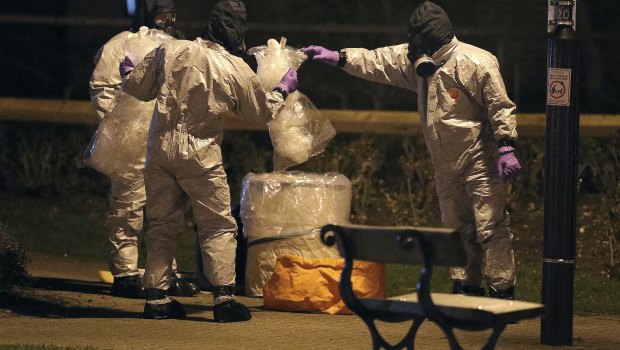 Investigators in protective suits work in Salisbury, England, on Tuesday.