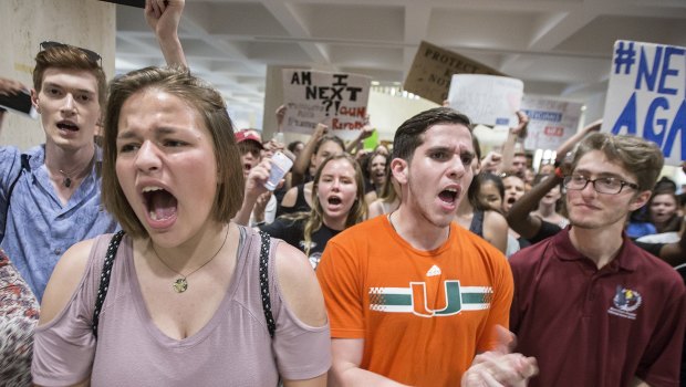 Students chant protest slogans outside the Florida House of Representatives chamber inside the Florida Capitol.