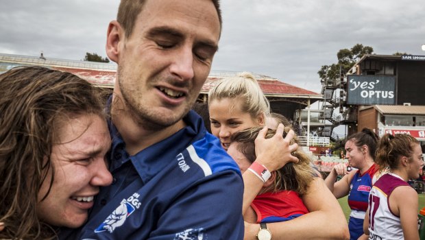 Suspended Western Bulldogs captain Katie Brennan  celebrates with coach Paul Groves after the Bulldogs win the AFLW grand final.