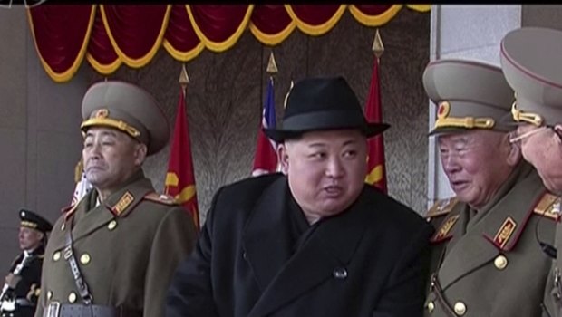In this image made from video by North Korea's KRT, leader Kim Jong-un speaks with military officials during a parade in Pyongyang.