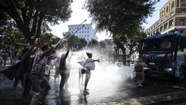 Italian police use water cannons to disperse migrants in downtown Rome last year.