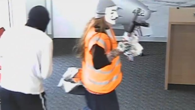 Police think the masked thief's long hair could be a wig.