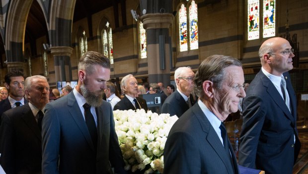 Campbell Walker, far right, helps lead his father's coffin out of the cathedral after the state funeral.