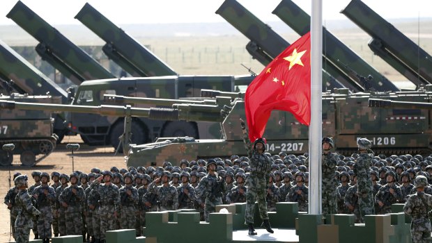 Chinese People's Liberation Army troops perform a flag raising ceremony at Zhurihe training base in north China's Inner Mongolia Autonomous Region.
