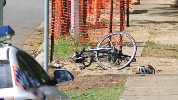 Police investigate a fatal cyclist crash in Indooroopilly.
