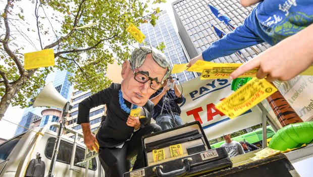 Tax campaigners rally outside a Senate inquiry into resources. 