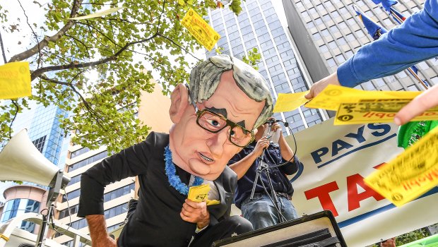 Tax campaigners rally outside a Senate inquiry into resources. 