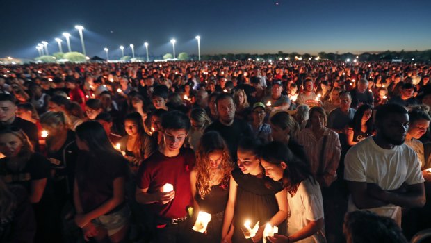 People attend a candlelight vigil for the victims of the Wednesday shooting at Marjory Stoneman Douglas High School, in Florida.