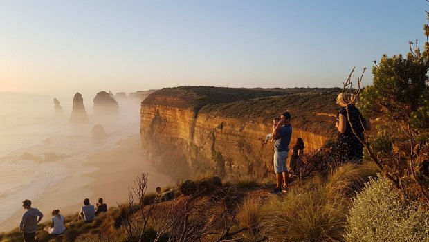 Tourists at the Twelve Apostles ignoring safety barriers to get a better view. 