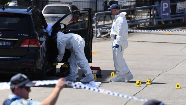 Forensic officers scour Mick Hawi's SUV for clues following the shooting at Rockdale.
