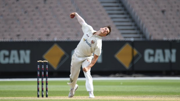 On a roll: Queenland's Mitchell Swepson sends down a delivery on day three at the MCG.