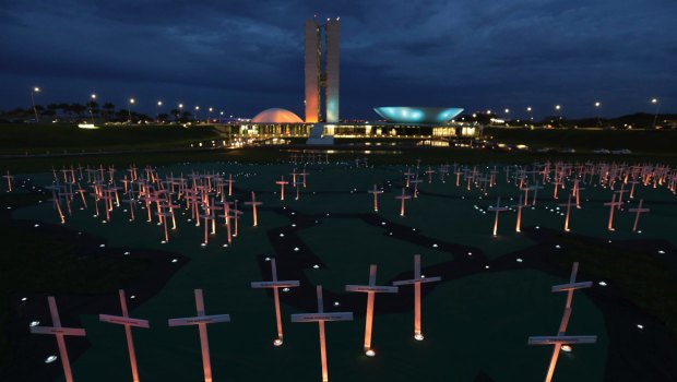 Crosses depicting people murdered for defending the forest stand on a large map of the Amazon, in Brasilia, last year.