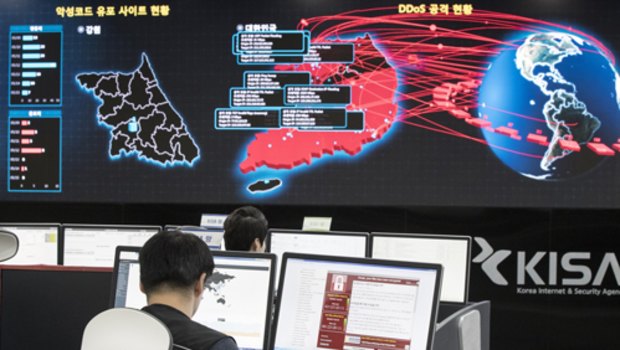 Employees watch electronic boards monitoring possible ransomware cyberattacks at the Korea Internet and Security Agency in Seoul, South Korea.