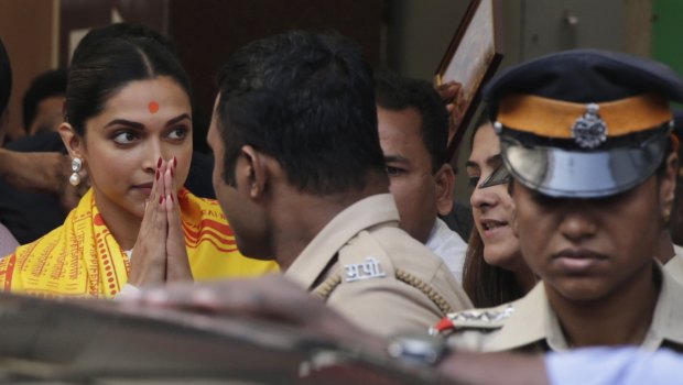 Bollywood actor Deepika Padukone, left, leaves after offering prayers at a Hindu temple ahead of the release of her upcoming film "Padmaavat" in Mumbai, India. 