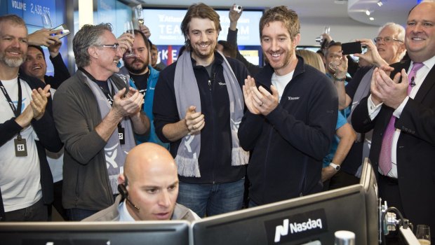 Mike Cannon-Brookes (left, with scarf) and Scott Farquhar watch as Atlassian's shares open on the Nasdaq.  