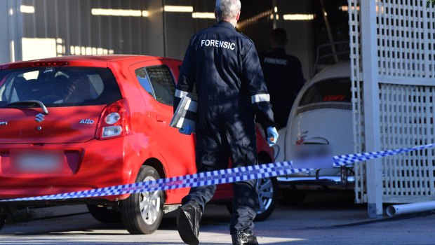Homicide squad detectives and forensic scientists at the property on Thursday.