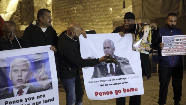 Palestinians hold posters of US Vice-President Mike Pence as they protest against his visit to Israel.