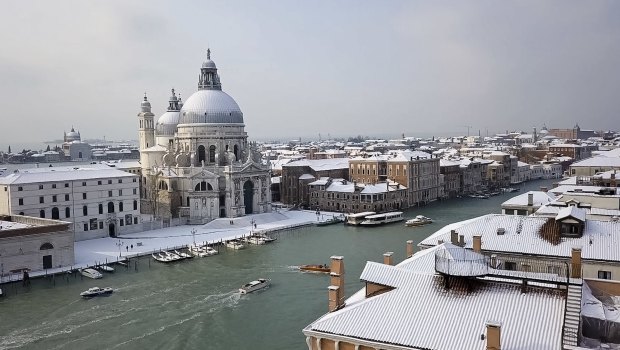 Santa Maria della Salute Basilica on the Grand Canal in Venice covered by a blanket of snow.