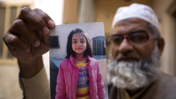 Mohammed Amin shows a picture of his seven year-old daughter, Zainab Ansari in Kasur, Pakistan.