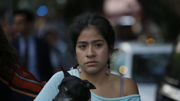 A woman holds her dog in the aftermath of a 7.2-magnitude earthquake that shook Mexico City.