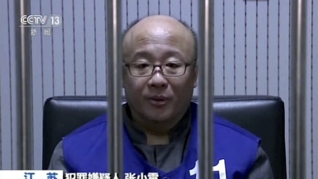Qianbao founder Zhang Xiaolei speaks with police while in custody in Nanjing in eastern China's Jiangsu province. 