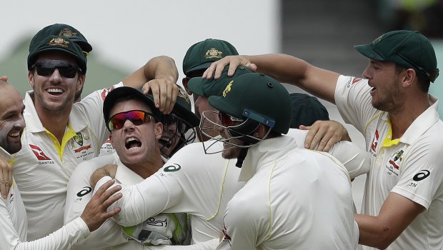 Tirade: David Warner is mobbed by teammates after the run out of  AB de Villiers for a duck.