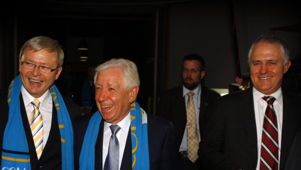Then PM Kevin Rudd wears a Come Play! scarf with Frank Lowy and then Opposition Leader Malcolm Turnbull in June 2009.